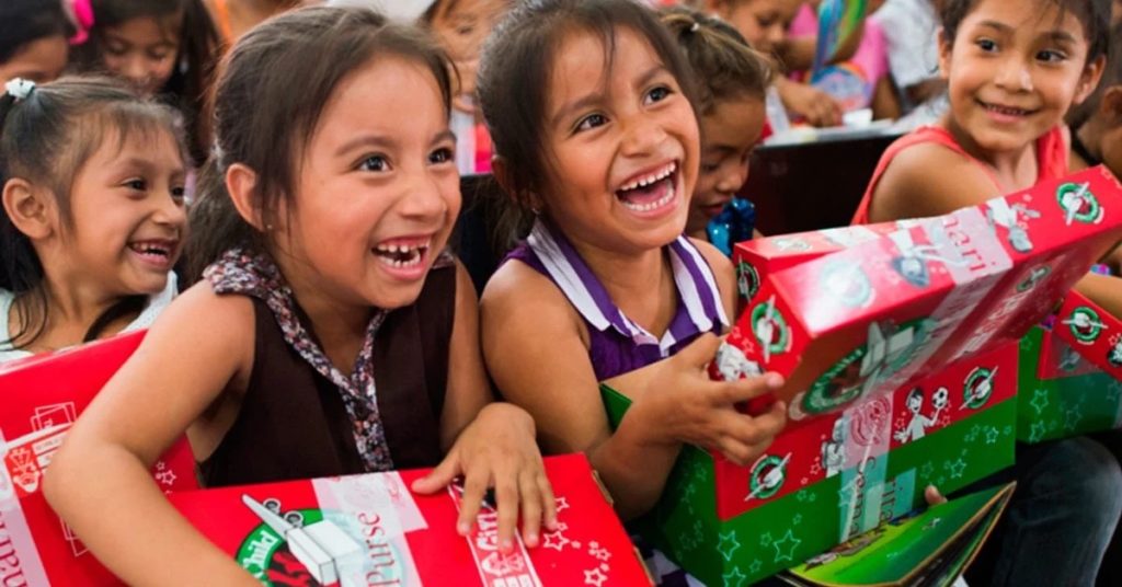 kids smiling as they open their OCC box
